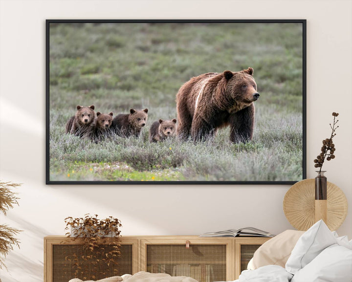 The large canvas print titled "Queen of the Tetons, 399 Grizzly Bear Cubs" showcases majestic wildlife photography of a bear and her cubs walking through the grass. This stunning canvas wall art, handmade in the USA, adds a charming touch to any room with its rustic decor appeal.