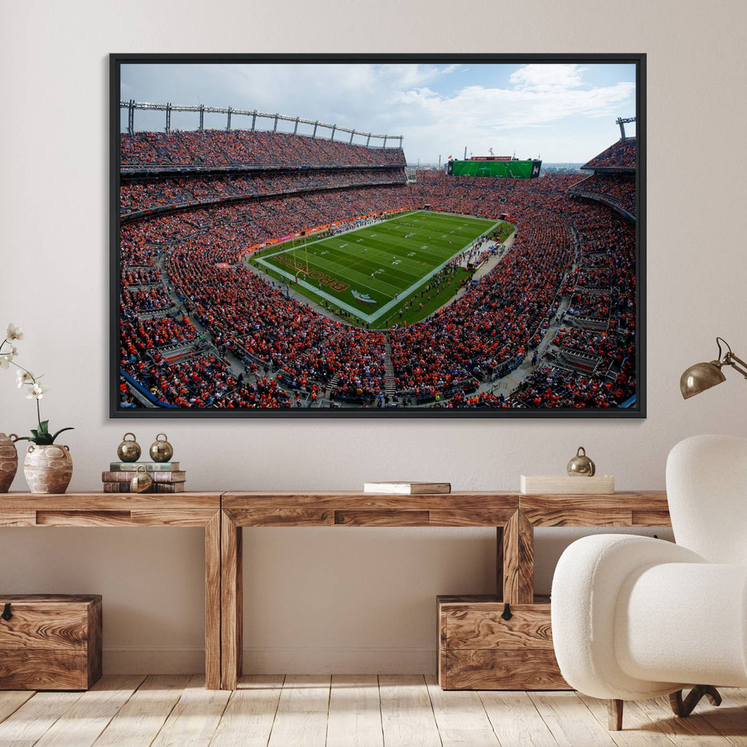 The Denver Broncos Football Print features a vibrant, fan-filled orange stadium overlooking the football field.