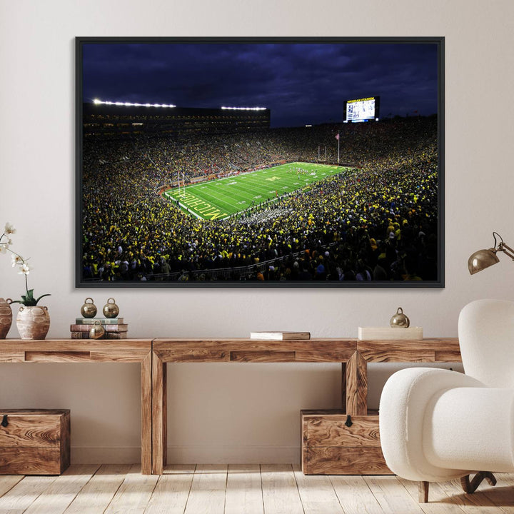 A painting of the packed Michigan Wolverines football stadium at night.