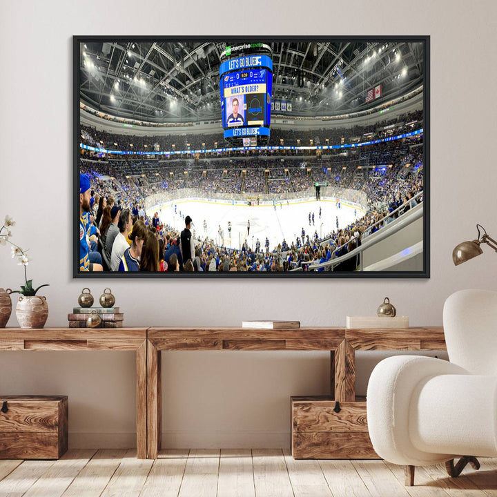 Wall art prints depicting the bustling scenes of the St. Louis Blues being cheered on by a full house at the Enterprise Center, beneath a large scoreboard.