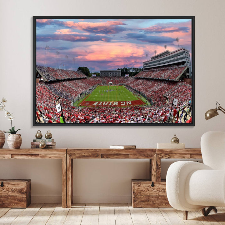 The wall art captures an NC State Wolfpack game under a vibrant sunset on triple canvas.