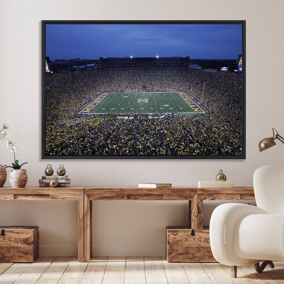 Wall art featuring an aerial shot of Michigan Stadium at dusk, showcasing the University of Michigan Wolverines M logo.