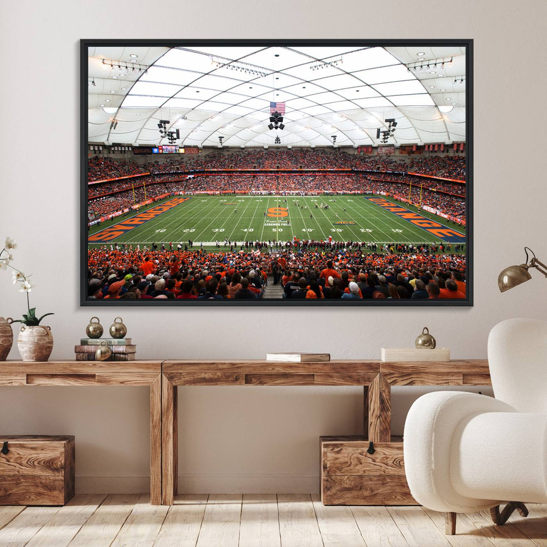 Fans fill the Syracuse JMA Wireless Dome, highlighted in orange and blue under a vaulted roof on this premium canvas print of the scene.