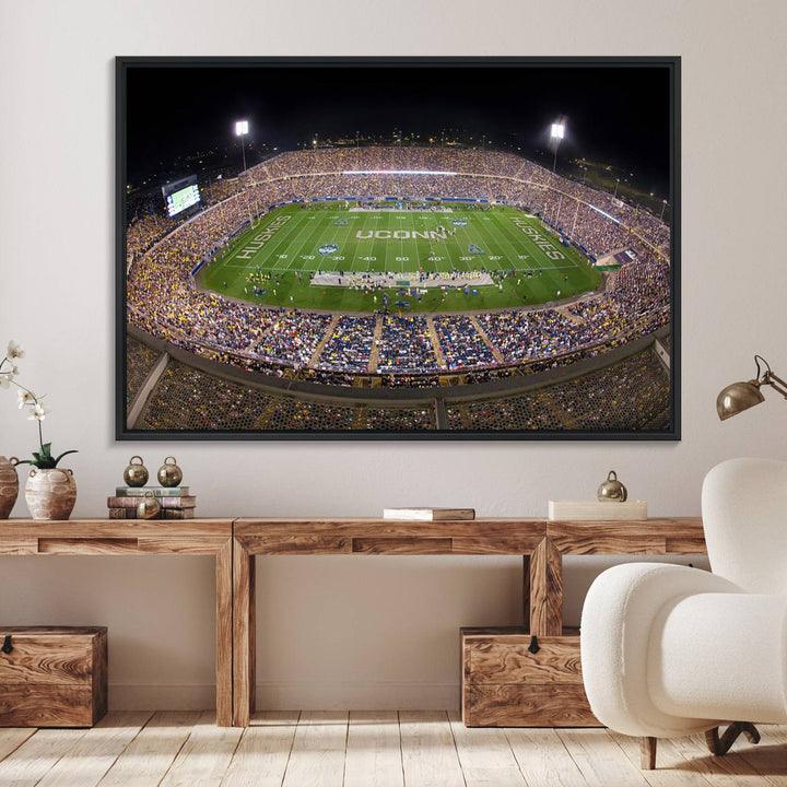 A large football stadium at night, featuring the UCONN Huskies, is depicted on the East Hartford Pratt & Whitney Stadium Wall Art Canvas Print.