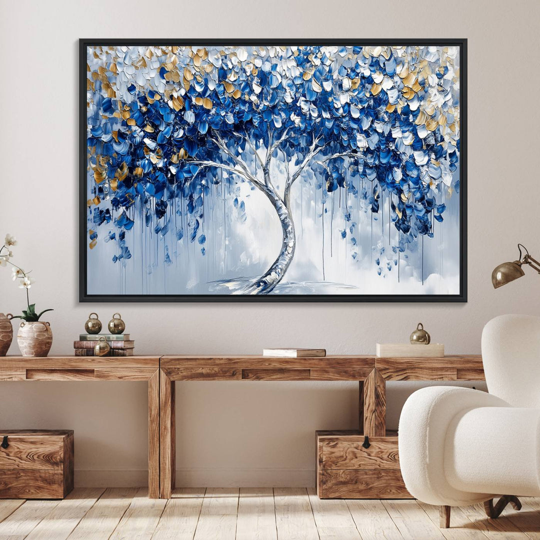 The Blue and Gold Abstract Tree Wall Art showcases a swirl trunk and features blue, silver, and gold leaves on a framed canvas print.