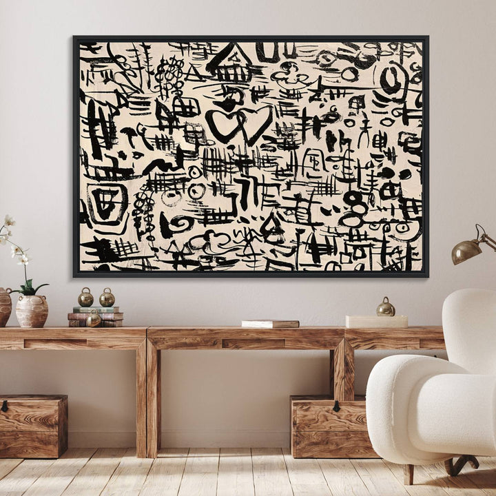 The Abstract Love and Chaos canvas is a museum-quality print featuring black symbols on a beige background, adorned with a heart and scribble design. It is framed to enhance its artistic appeal.