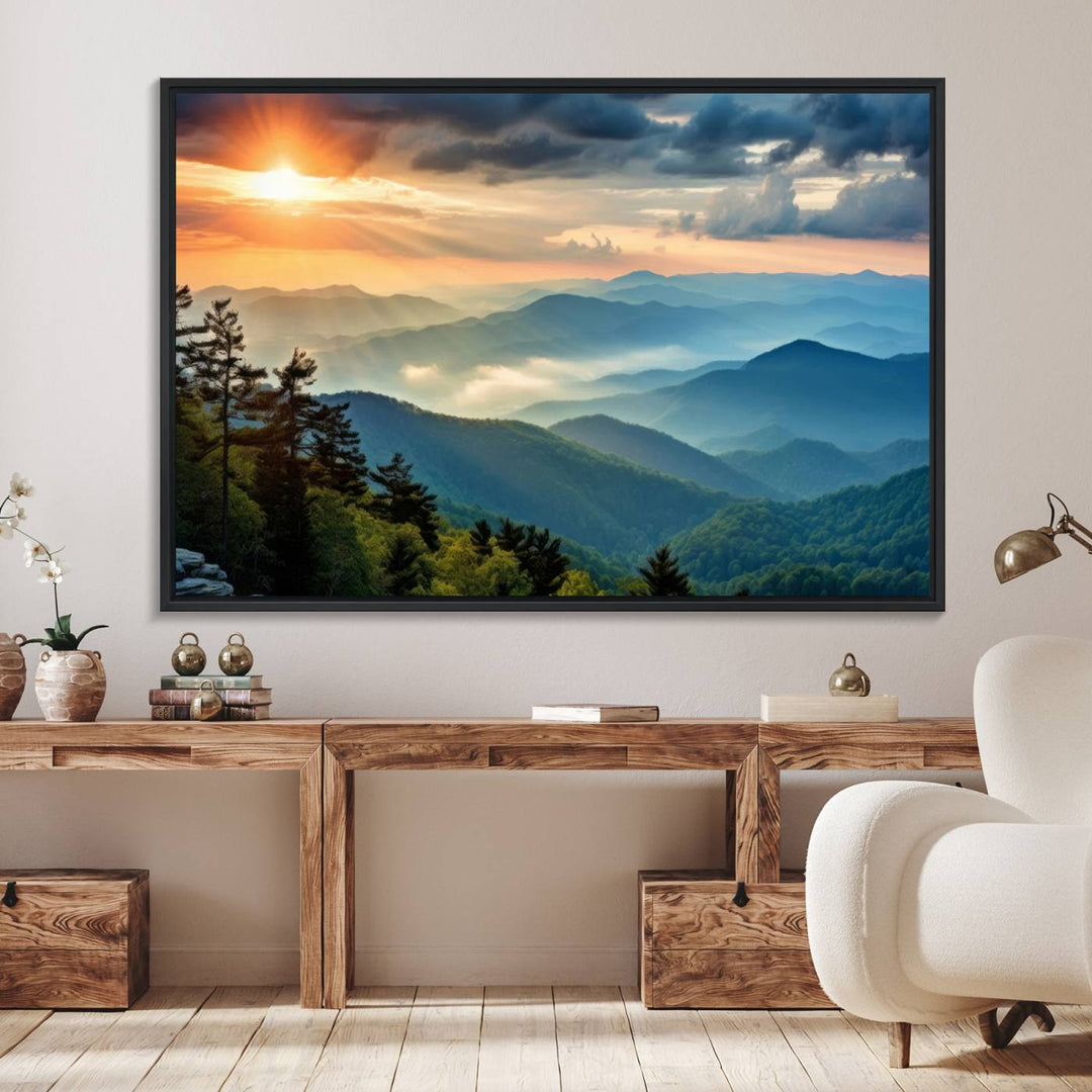 The wall art, titled Sunrise Over Mountain Range, is a canvas print that beautifully depicts layers of hills, scattered trees, and a partly cloudy sky.