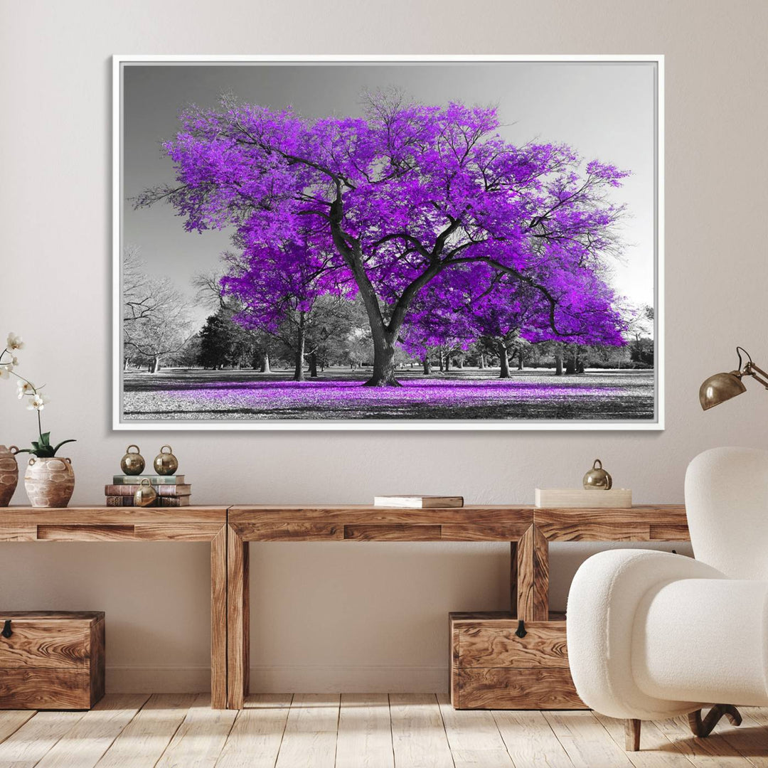 The Big Purple Tree Wall Art Canvas Print showcases a vibrant purple tree set against a black-and-white landscape.