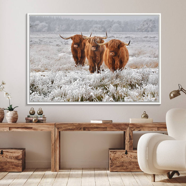 The Highland Cows in Snow canvas showcases three cattle in a frosty field.