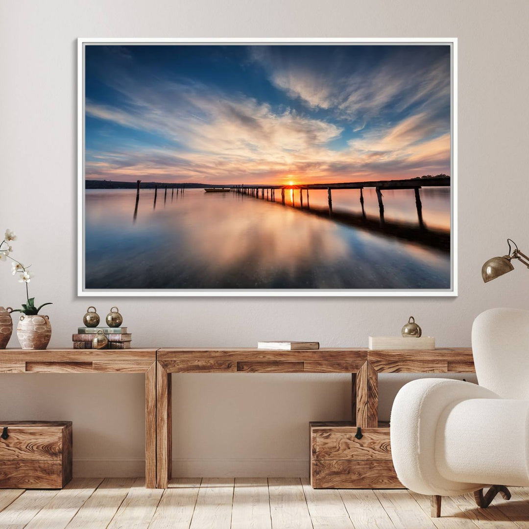 The Sunset Pier Canvas features a serene coastal landscape with vibrant hues under cloudy skies, ideal for modern decor.