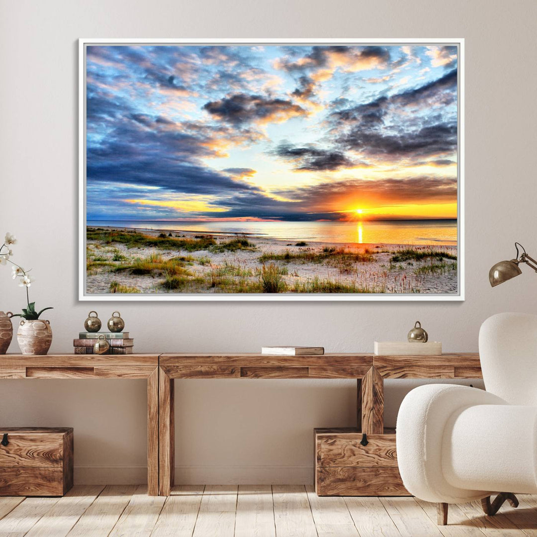 The Sunset On The Ocean canvas wall art features a beautiful beach sunset with grass and clouds.