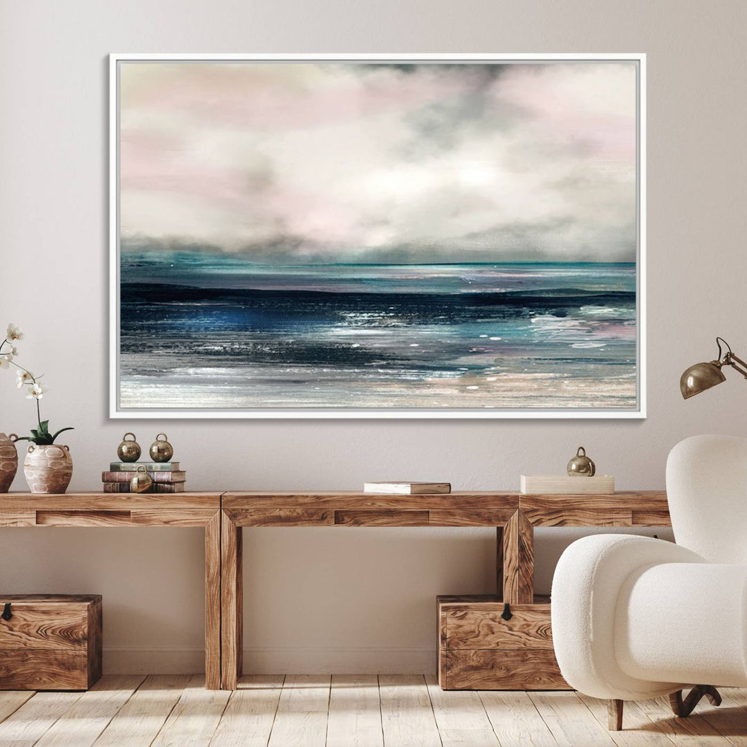 A contemporary abstract wall art canvas print in pastel pink, teal, and gray tones hangs on the wall.