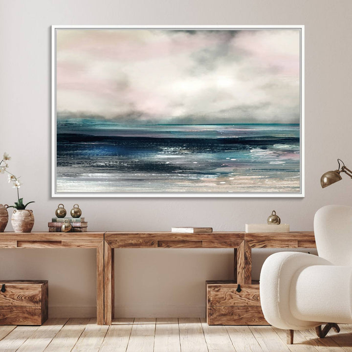 A contemporary abstract wall art canvas print in pastel pink, teal, and gray tones hangs on the wall.