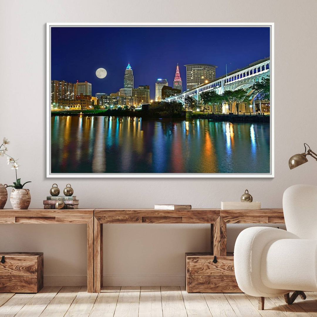 Cleveland City Lights Night Skyline Wall Art canvas showcases a moonlit cityscape reflected on water.