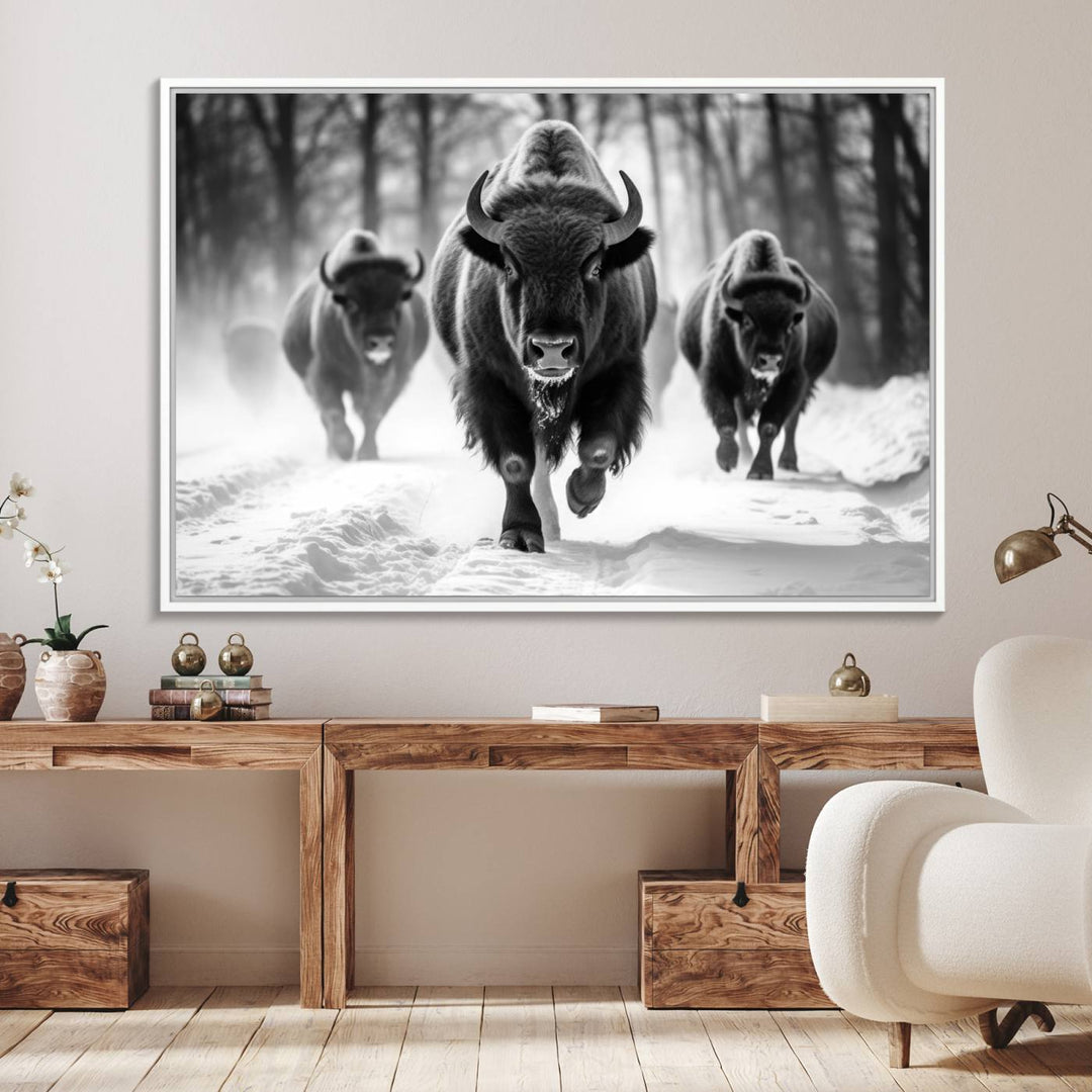 The Buffalo Wall Art Canvas Print of bison running through snow adorns the wall.