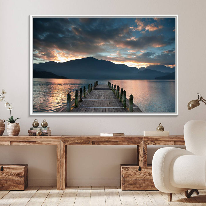 The Mountain Lake Wood Pier Canvas Wall Art depicts a serene lake and mountains, enhancing the beauty of any space.