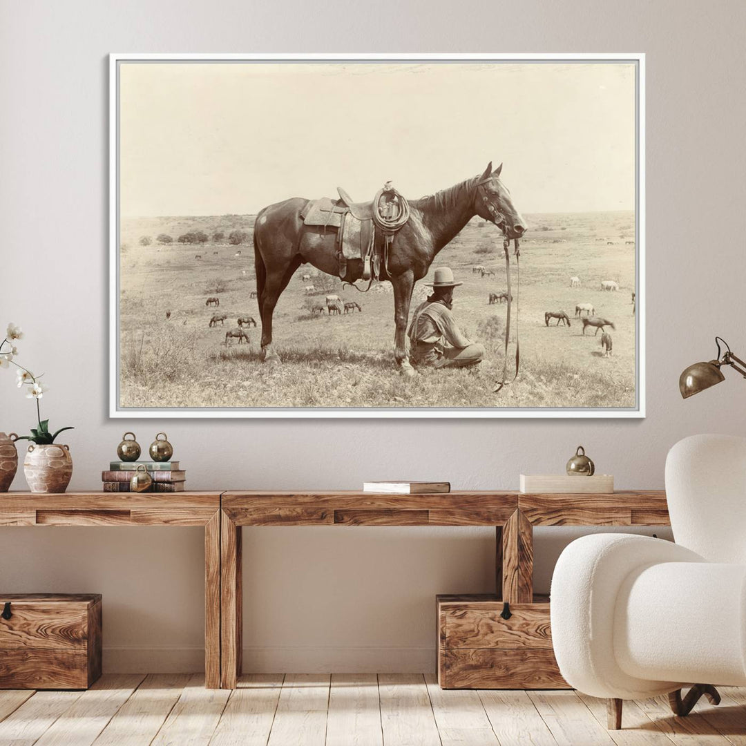 Cowboy Wall Art - Vintage Western Horse Canvas Print features a cowboy kneeling by his horse in a field.