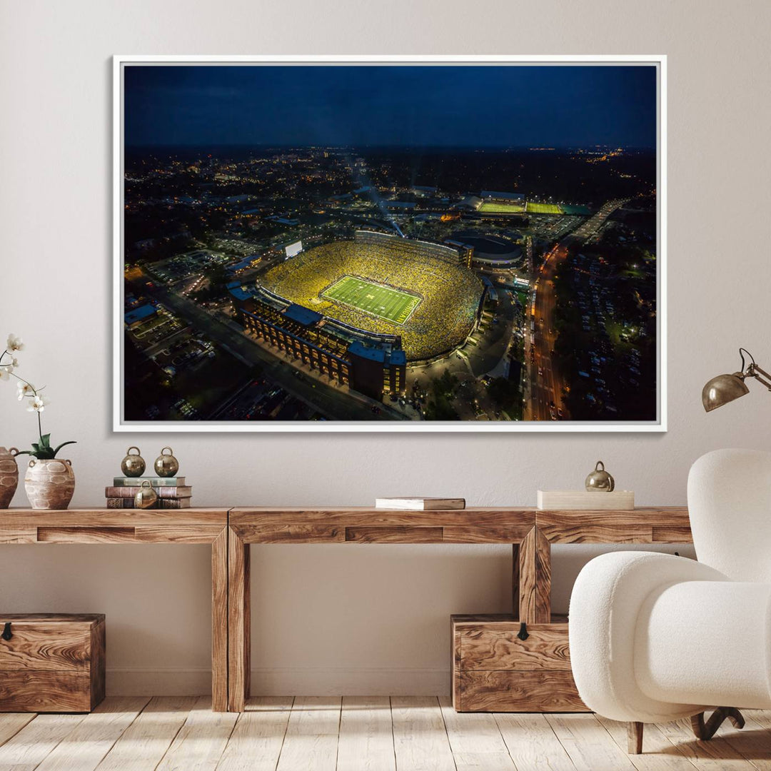 Aerial view of Michigan Stadium at night, surrounded by city lights, depicted on a Michigan Wolverines wall art canvas print.