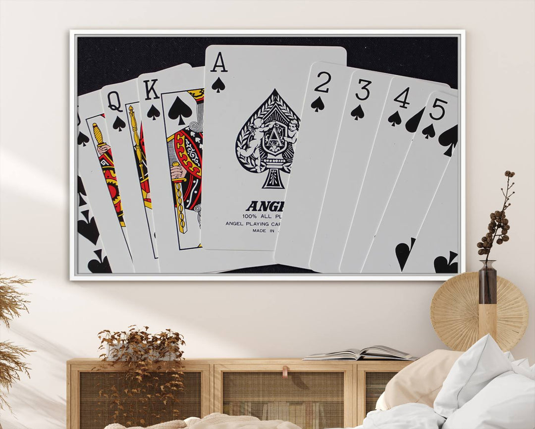 The Poker Wall Art - Playing Cards Canvas Wall Art Print features an Ace of Spades and Royal Flush design. This piece adds a classic charm to any space with its subtle emphasis on the Ace of Spades, making it perfect for game room decor.