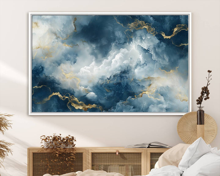 The "Large Abstract Print - Luxe Blue and Gold Abstract Canvas Wall Art" features a bold cloudscape design with swirling white patterns, ideal for modern home decor in living rooms or offices.