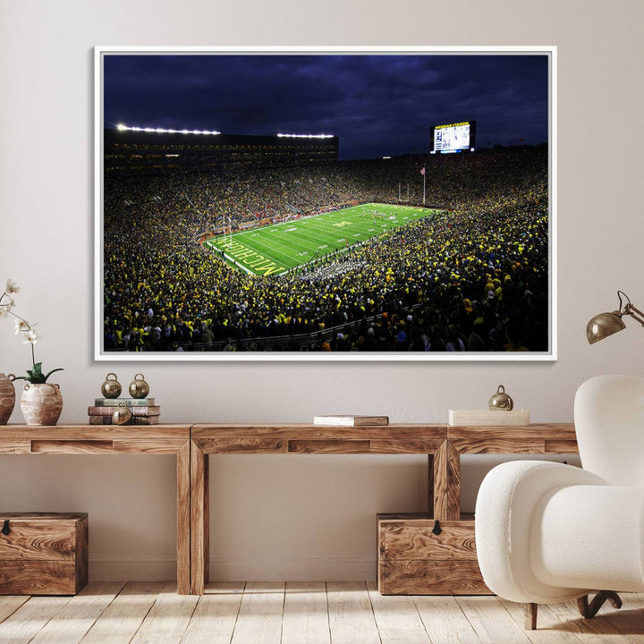 A painting of the packed Michigan Wolverines football stadium at night.