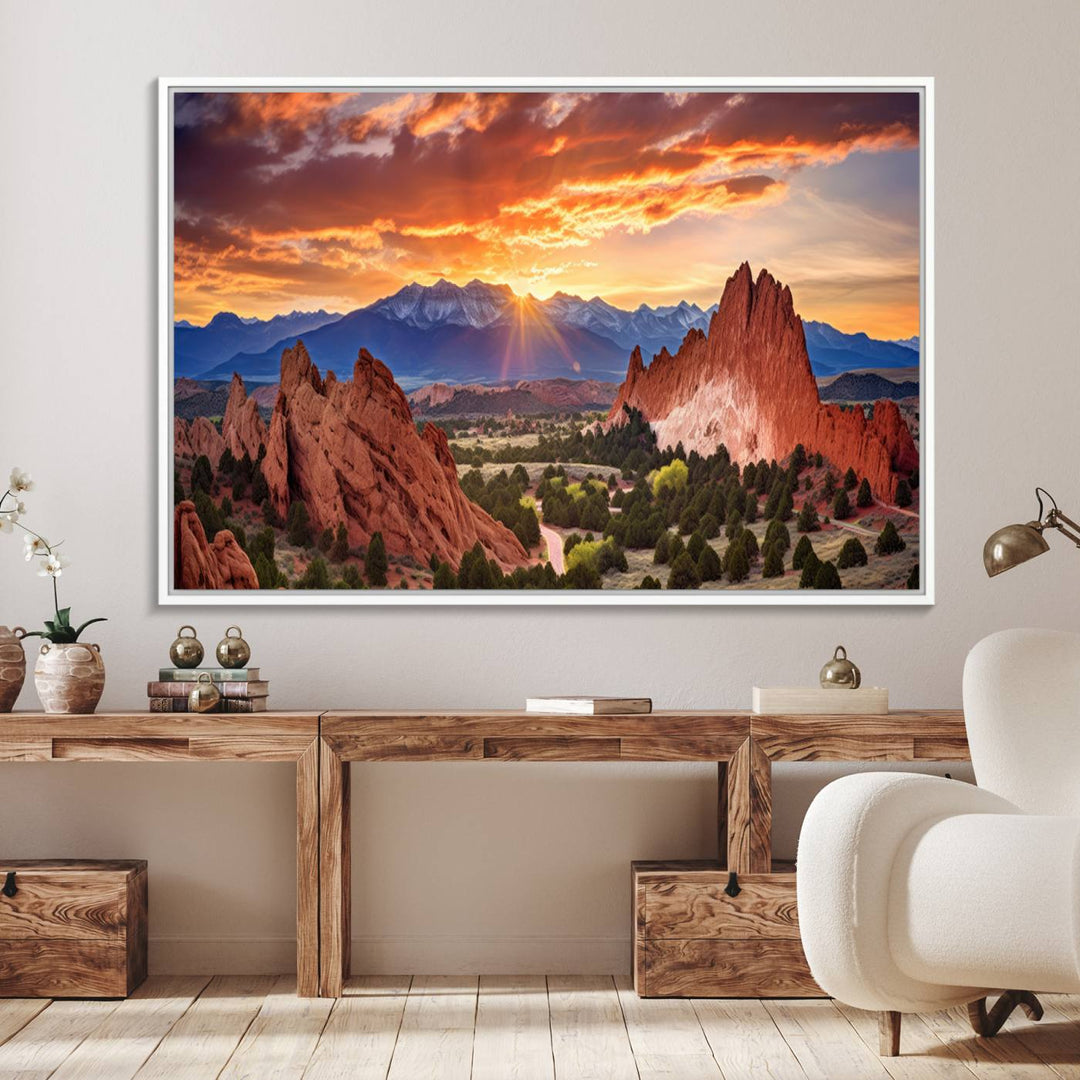 A vibrant sunset over the Rocky Mountains with red rocks.