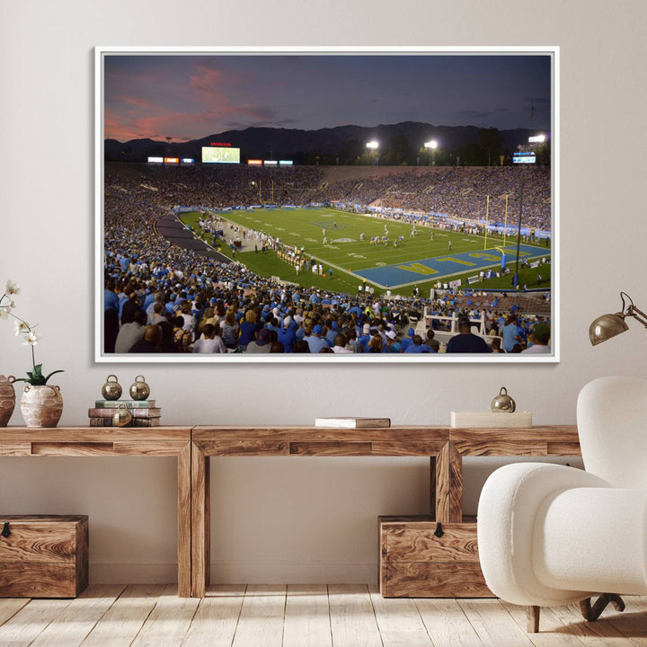 Admire the stunning wall art canvas depicting a UCLA Bruins game with a sunset over the Pasadena Rose Bowl Stadium.