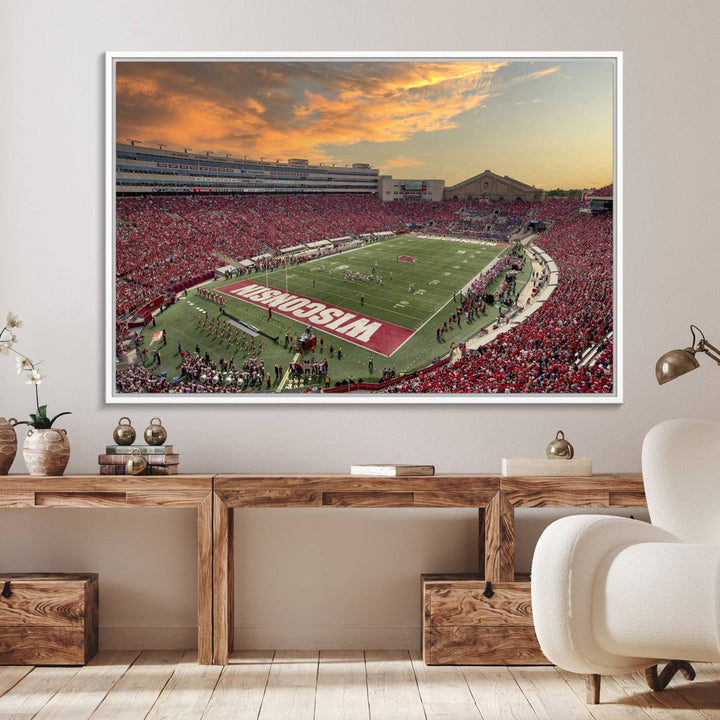 The wall features a Wisconsin Badgers wall art canvas print, capturing the vibrant atmosphere of a full Camp Randall Stadium at sunset.