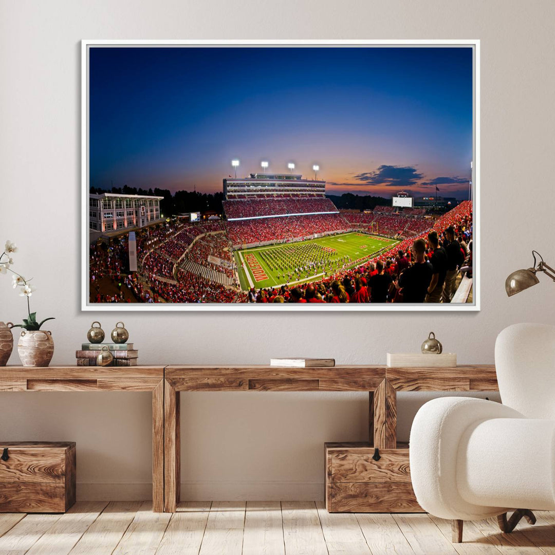 The Wolfpack Football Team Print captures a band and crowd at dusk in a premium canvas art style at Raleigh Carter-Finley Stadium.