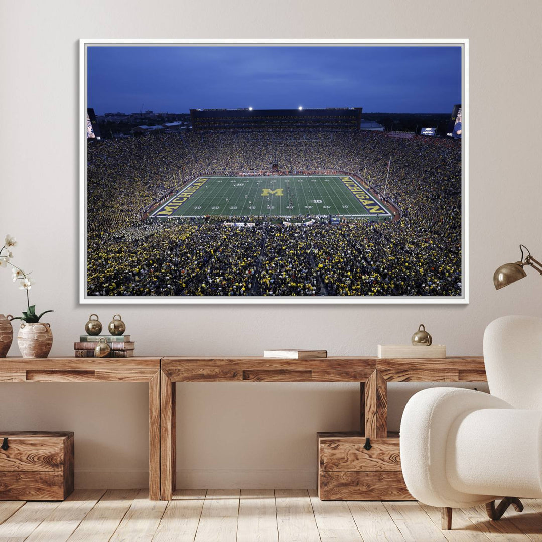 Wall art featuring an aerial shot of Michigan Stadium at dusk, showcasing the University of Michigan Wolverines M logo.