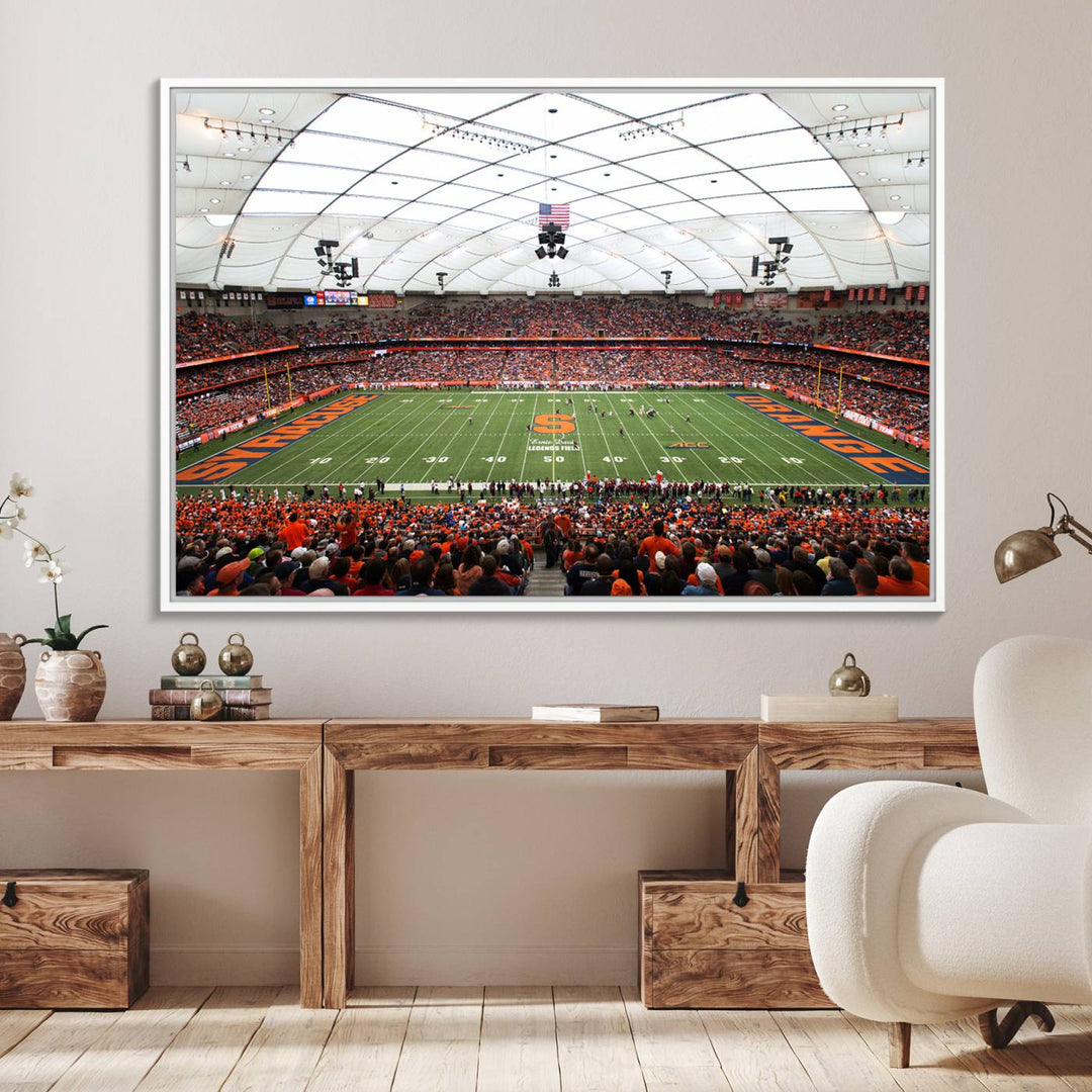 Fans fill the Syracuse JMA Wireless Dome, highlighted in orange and blue under a vaulted roof on this premium canvas print of the scene.