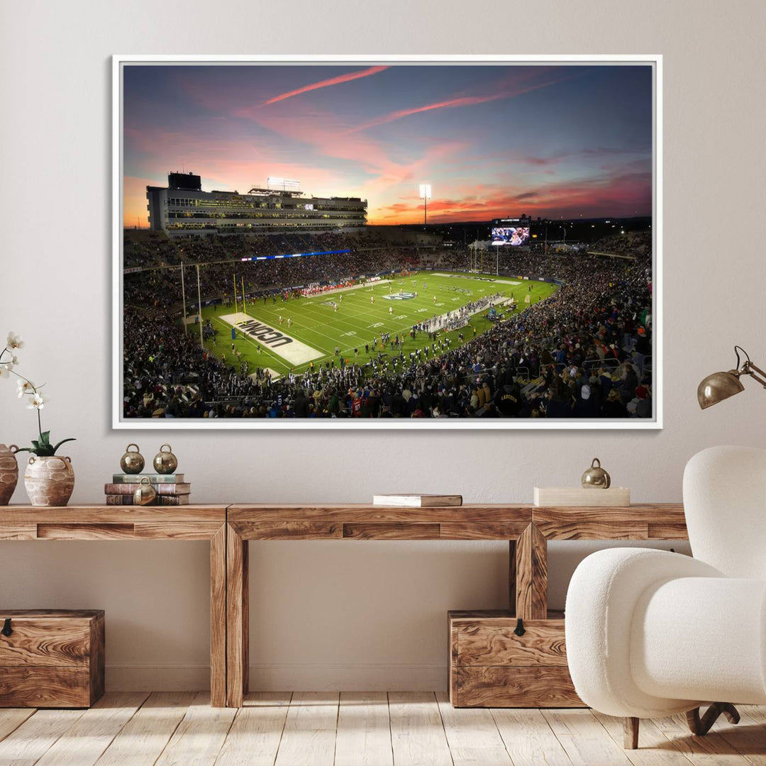 This wall art canvas print captures UCONN Huskies fans energizing a sunset scene at East Hartfords Pratt & Whitney Stadium.