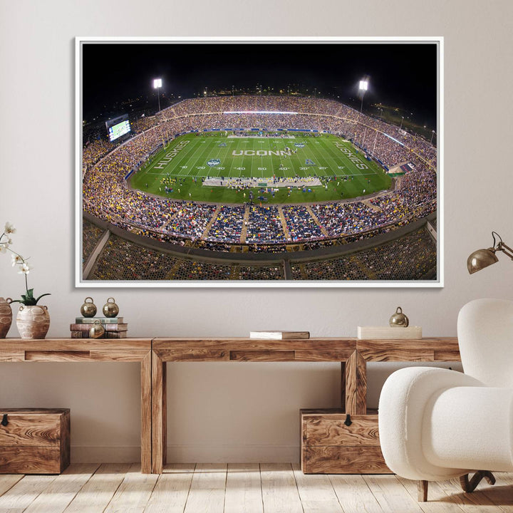 A large football stadium at night, featuring the UCONN Huskies, is depicted on the East Hartford Pratt & Whitney Stadium Wall Art Canvas Print.