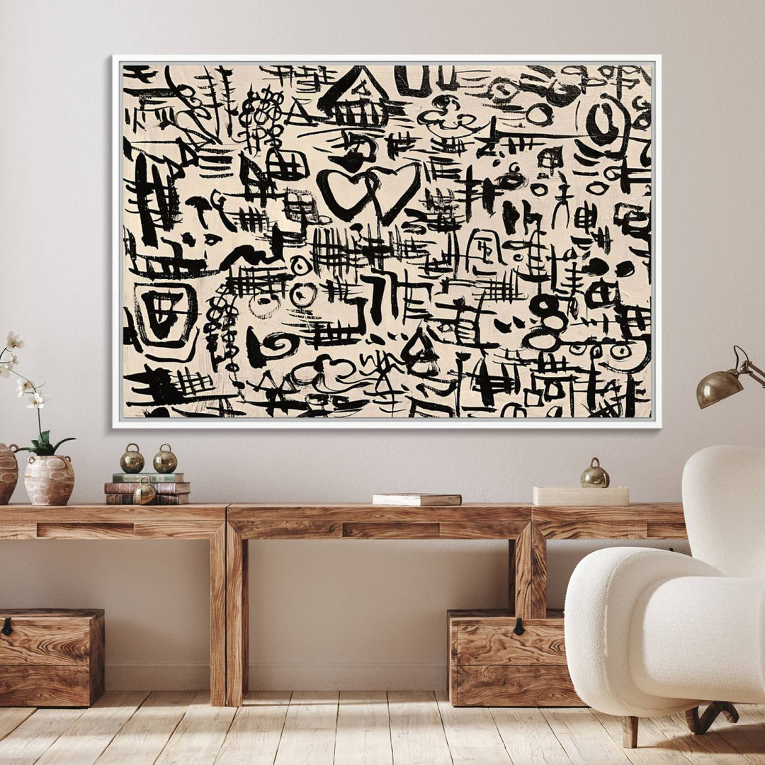 The Abstract Love and Chaos canvas is a museum-quality print featuring black symbols on a beige background, adorned with a heart and scribble design. It is framed to enhance its artistic appeal.