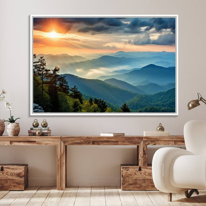 The wall art, titled Sunrise Over Mountain Range, is a canvas print that beautifully depicts layers of hills, scattered trees, and a partly cloudy sky.