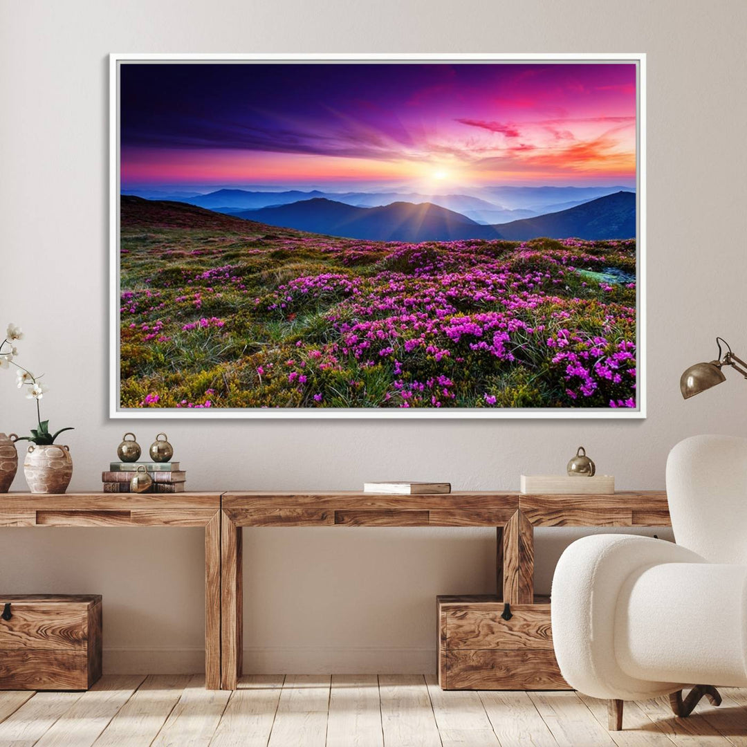 A 3-panel landscape photography canvas of a sunset over mountain meadows with purple wildflowers decorates the wall.