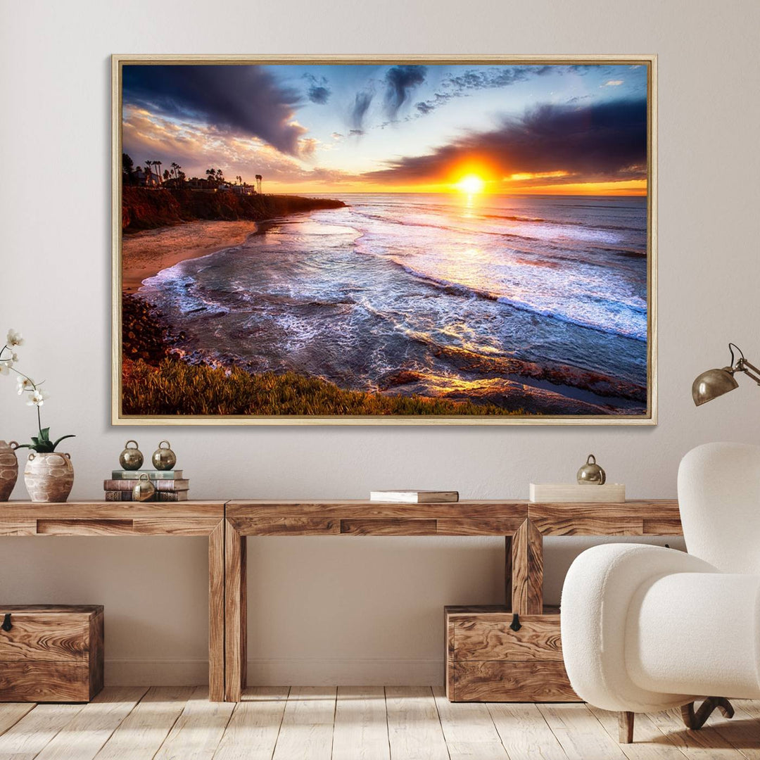 The California Coastline Sunset Canvas Art with waves adorns a wooden shelf.