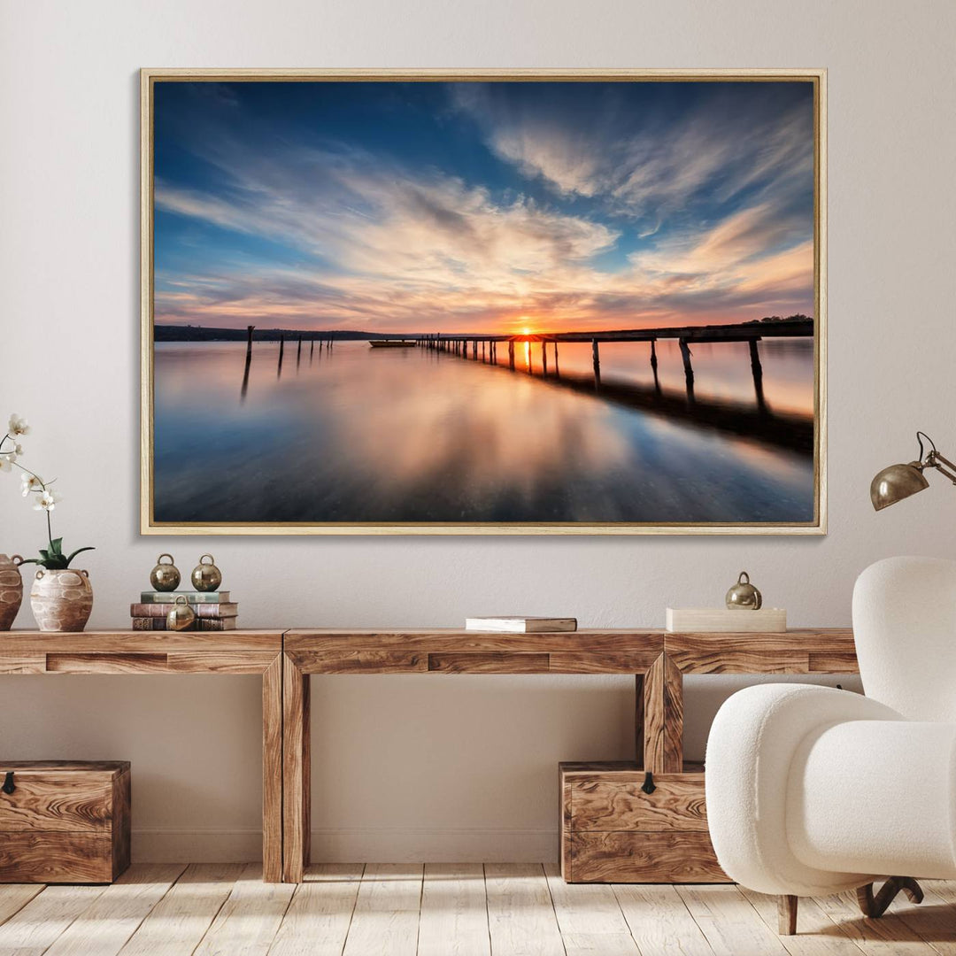 The Sunset Pier Canvas features a serene coastal landscape with vibrant hues under cloudy skies, ideal for modern decor.