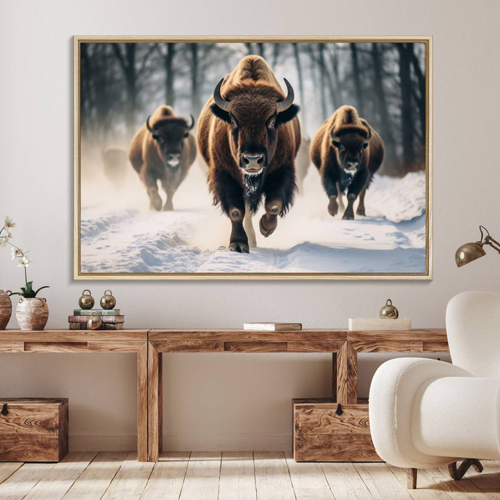 Wall art titled Cow Bighorn shows three bison running through snow in a forest.