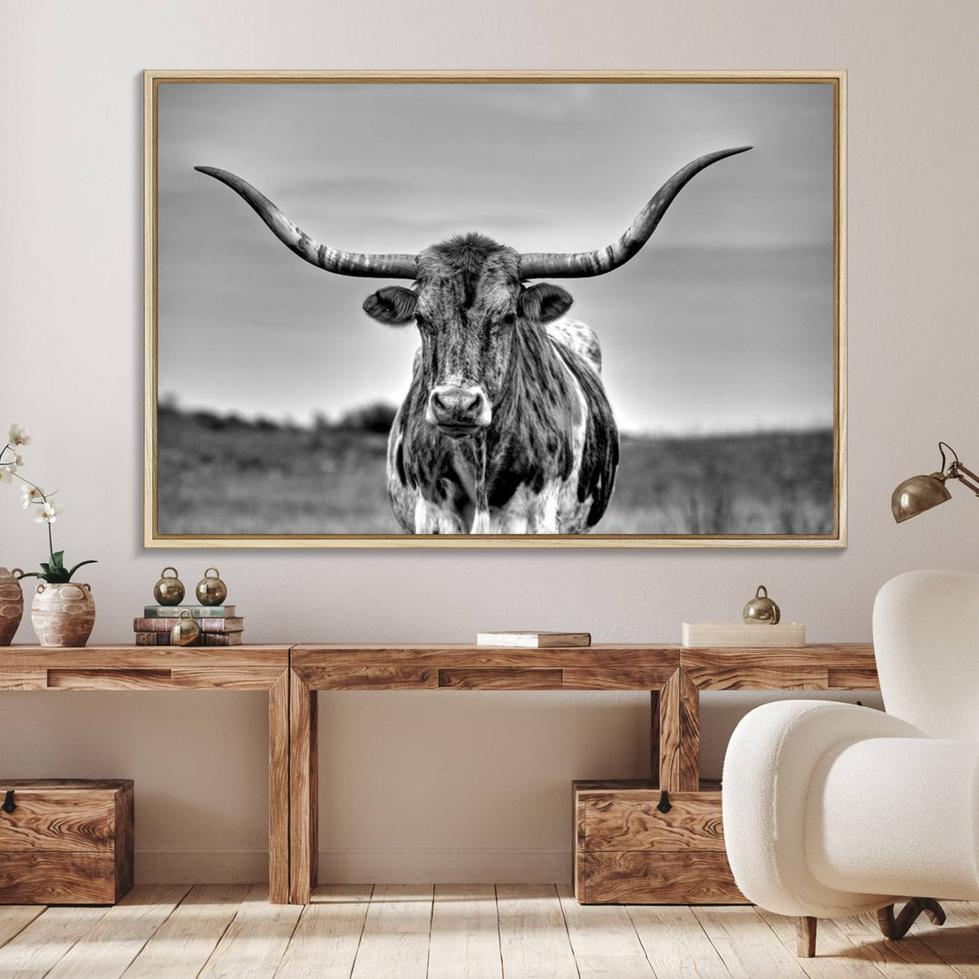 The Texas Longhorn Cow wall art, divided into three panels, is of gallery quality and displayed on a dark wall.