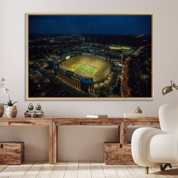 Aerial view of Michigan Stadium at night, surrounded by city lights, depicted on a Michigan Wolverines wall art canvas print.