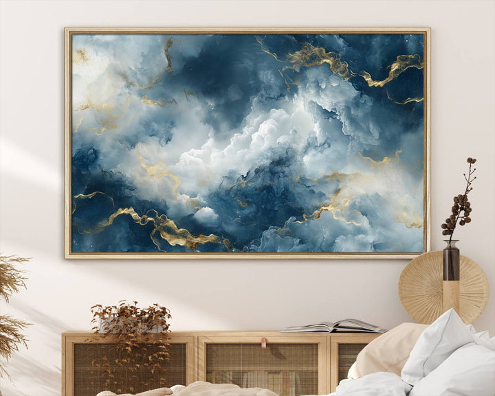 The "Large Abstract Print - Luxe Blue and Gold Abstract Canvas Wall Art" features a bold cloudscape design with swirling white patterns, ideal for modern home decor in living rooms or offices.