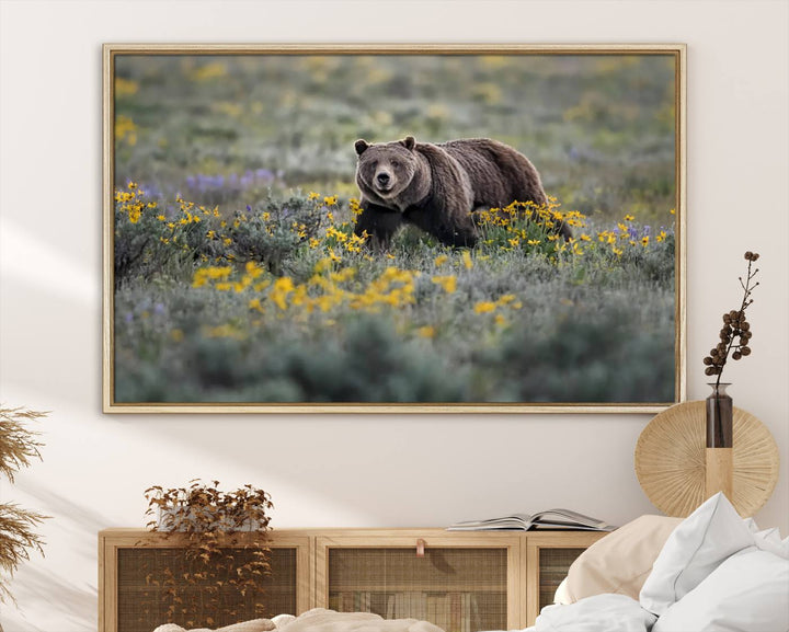 The "Grizzly 399 in Wild Flowers Wall Art Canvas Print" features a grizzly bear strolling through a field of yellow and purple flowers, beautifully showcased as a triptych. This handcrafted piece, proudly made in the USA, adds charm and sophistication to your space.