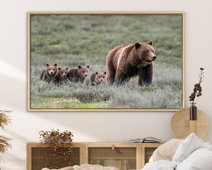 The large canvas print titled "Queen of the Tetons, 399 Grizzly Bear Cubs" showcases majestic wildlife photography of a bear and her cubs walking through the grass. This stunning canvas wall art, handmade in the USA, adds a charming touch to any room with its rustic decor appeal.