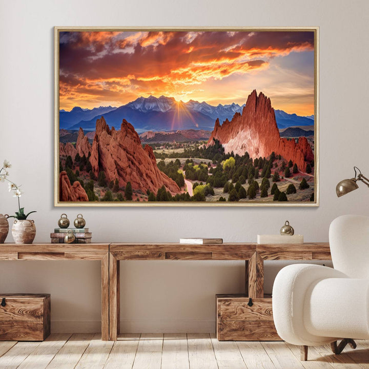 A vibrant sunset over the Rocky Mountains with red rocks.