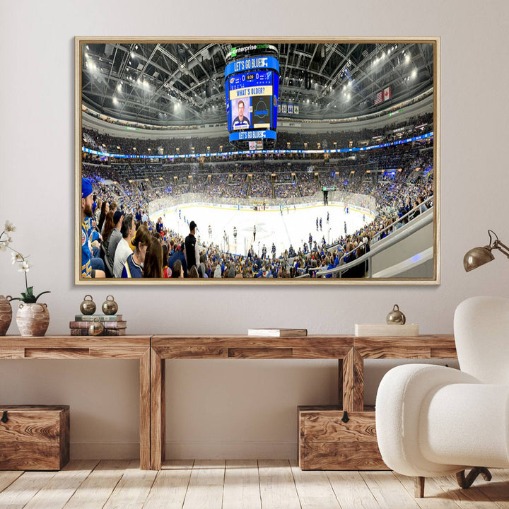 Wall art prints depicting the bustling scenes of the St. Louis Blues being cheered on by a full house at the Enterprise Center, beneath a large scoreboard.