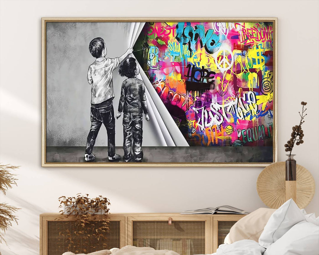 The Banksy Print - Street Art Canvas features a vibrant and bold image of two children lifting a curtain to reveal colorful graffiti. It's ready to hang, adding an urban modern decor vibe.