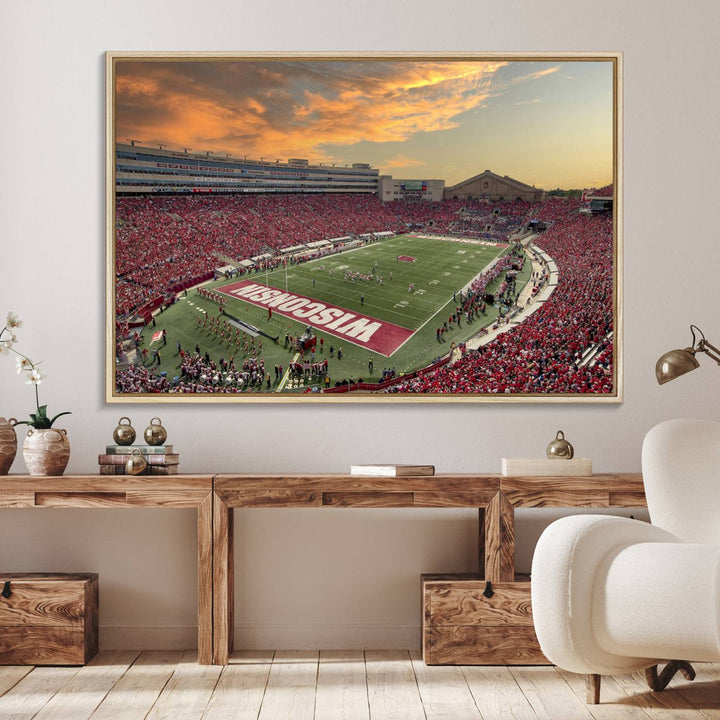 The wall features a Wisconsin Badgers wall art canvas print, capturing the vibrant atmosphere of a full Camp Randall Stadium at sunset.