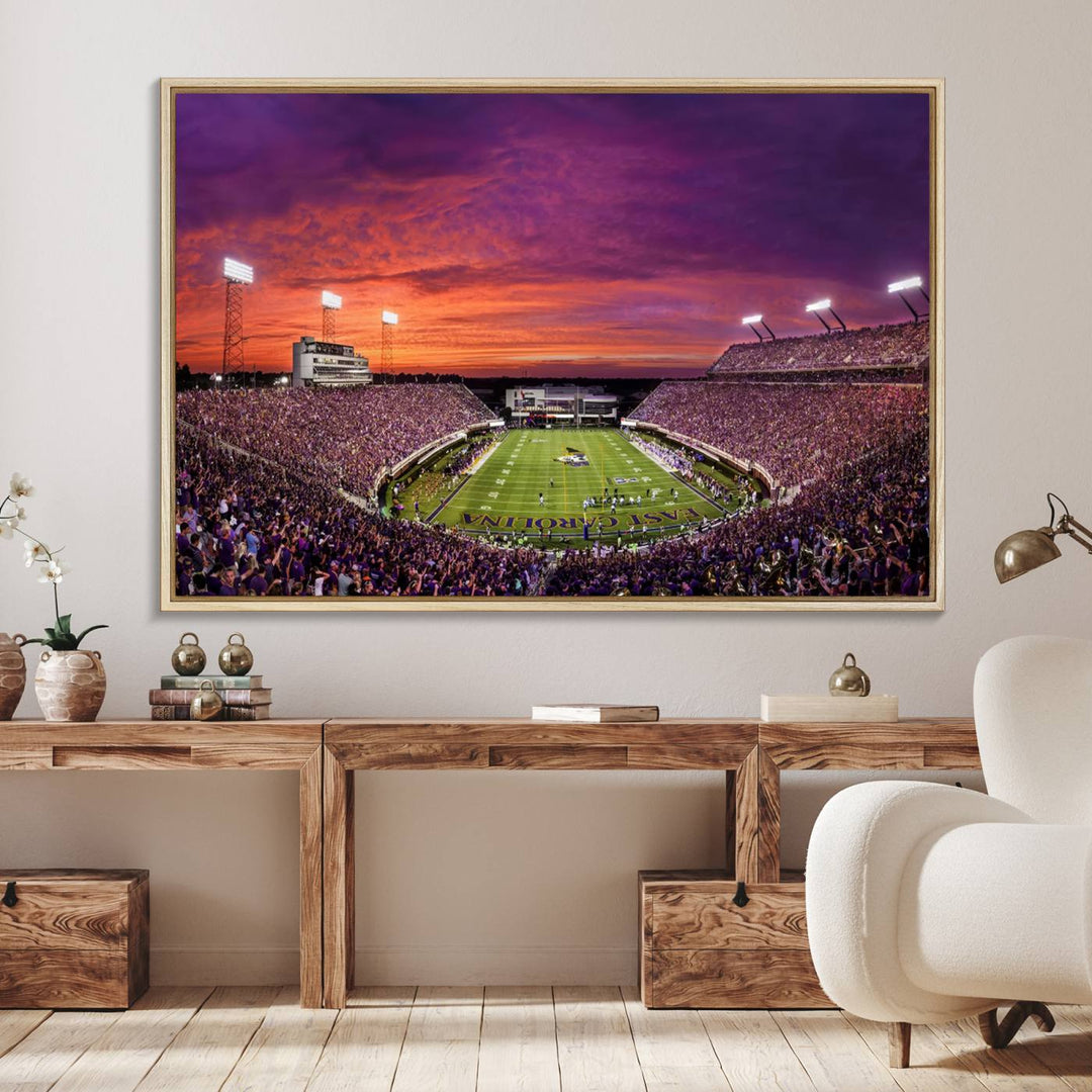 A sunset over Dowdy-Ficklen Stadium, Greenville, captured on museum quality canvas with vibrant purple and orange skies.