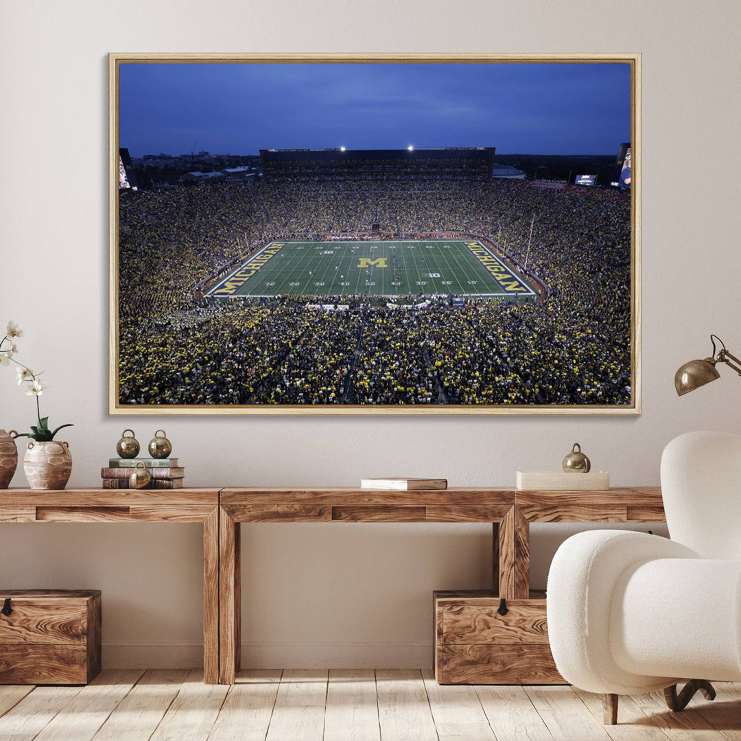 Wall art featuring an aerial shot of Michigan Stadium at dusk, showcasing the University of Michigan Wolverines M logo.